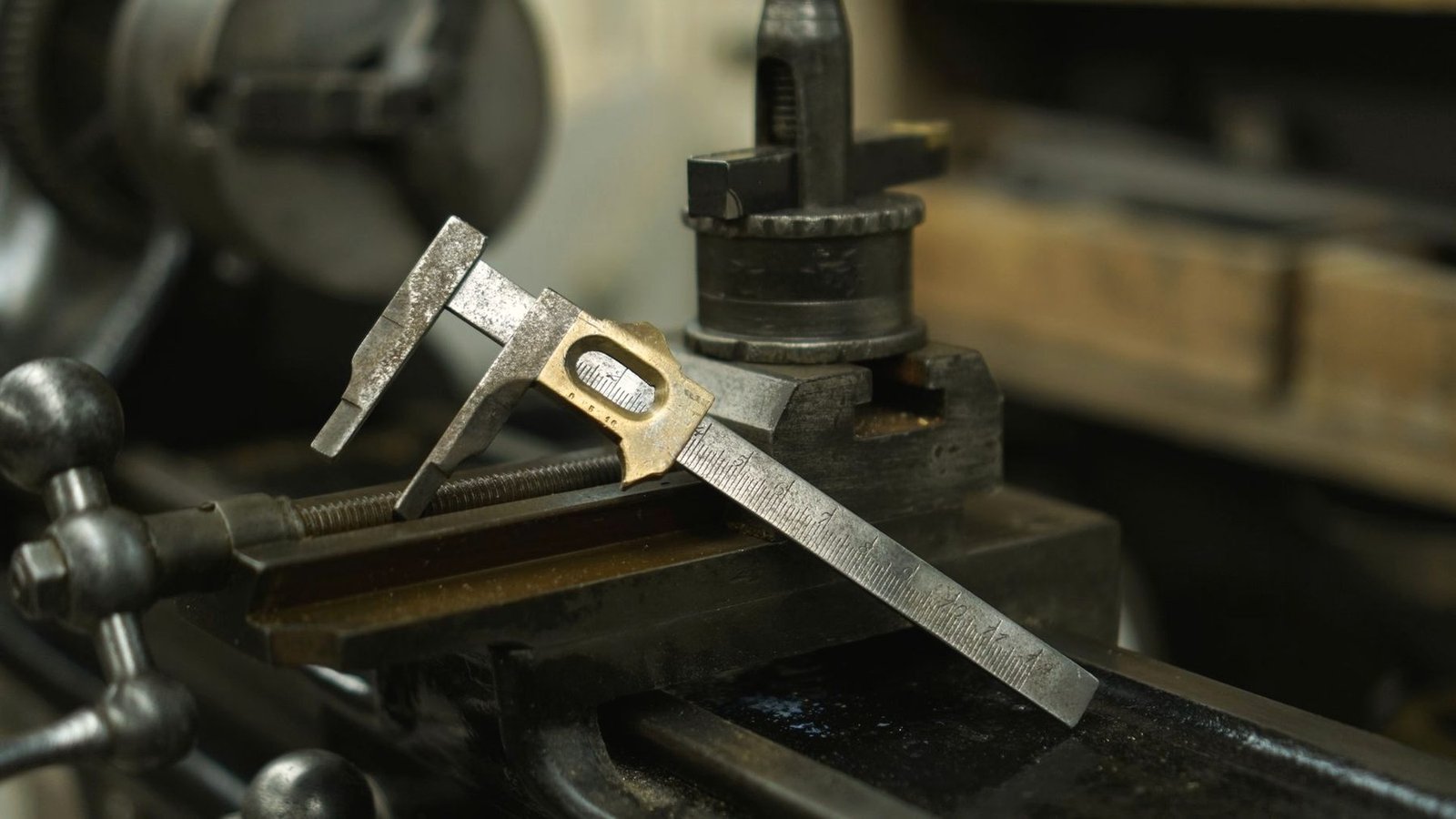 Vernier caliper resting on the bed of a lathe among metal shavings.