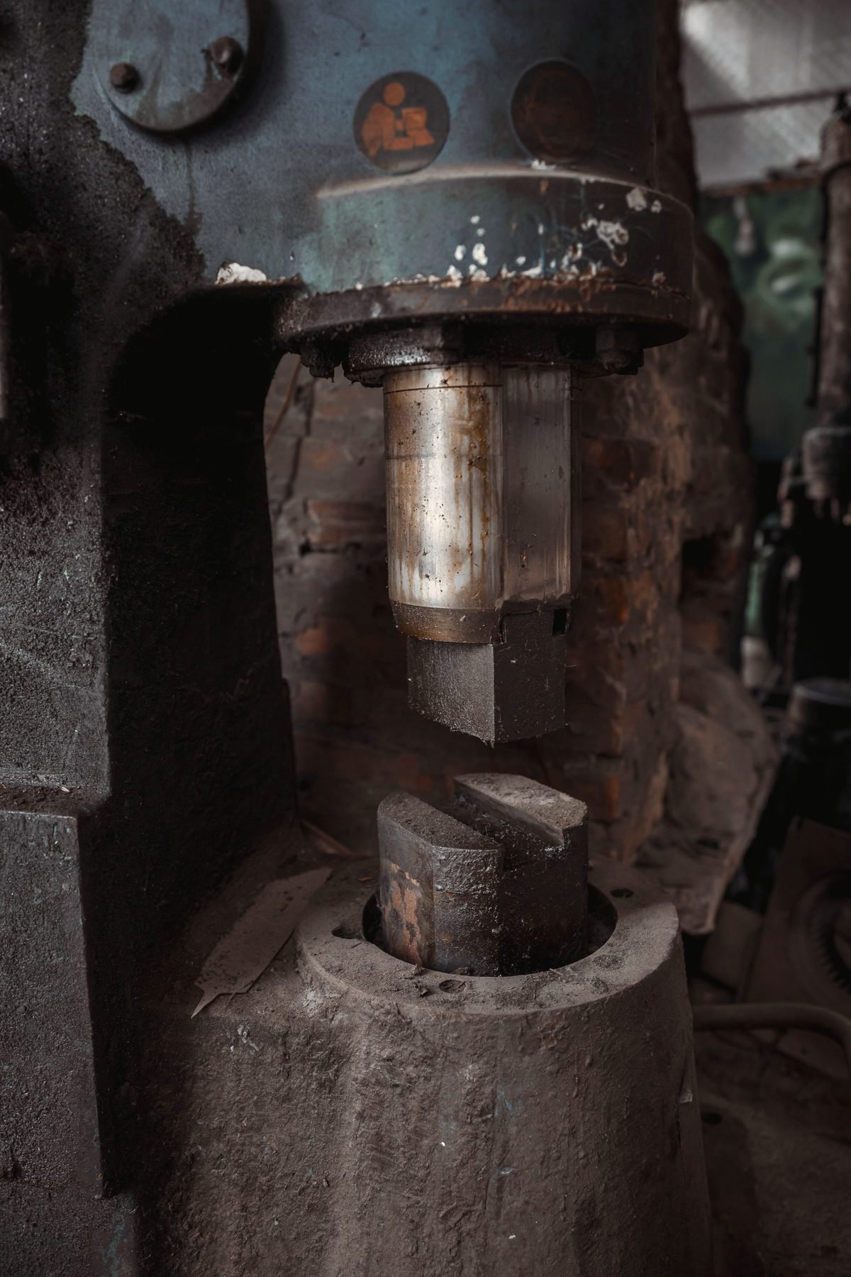 Heavy forged steel machine component sitting under shop lighting.